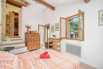a bedroom with a bed with a pink pillow on it at Mas du Rocher I Electio in Puget