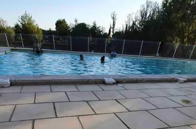 a group of people playing in a swimming pool at Belle Maisonette dans Residence 3* avec piscine partagée in Saint-Saturnin-lès-Avignon