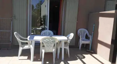 a white table and chairs on a patio at Belle Maisonette dans Residence 3* avec piscine partagée in Saint-Saturnin-lès-Avignon