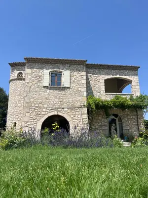 a stone building on top of a grassy hill at Chambre d'hôte au cœur de la Provence Eygalieres in Eygalières