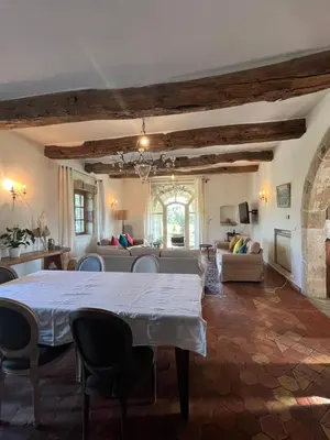 a living room with a table and a couch at Chambre d'hôte au cœur de la Provence Eygalieres in Eygalières