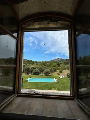 a window with a view of a swimming pool at Chambre d'hôte au cœur de la Provence Eygalieres in Eygalières
