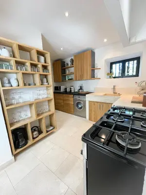 a kitchen with a stove top oven in a room at Superbe Mas Authentique du Luberon Courroussouvo in Oppède