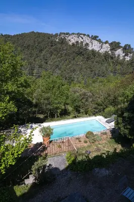 a swimming pool in front of a mountain at Superbe Mas Authentique du Luberon Courroussouvo in Oppède