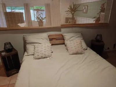 a bed with white sheets and pillows in a bedroom at Appartement Velleron-4 personnes in Velleron
