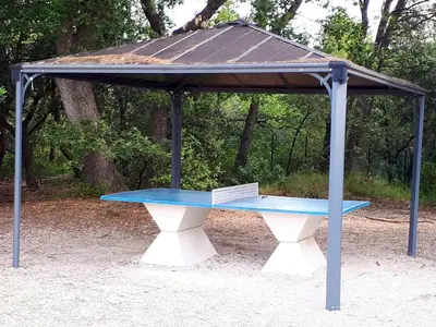 a picnic table with a book on top of it at Maison conviviale à Aubignan avec piscine partagée in Aubignan