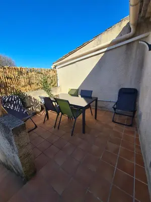 a patio with a table and chairs on a patio at Les oliviers in Ansouis