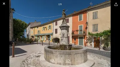 a fountain in the middle of a street with buildings at L’OBSERVATOIRE in Saint-Michel-lʼObservatoire