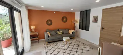 a living room with a couch against a wall at MyLuberon-Appartement au pied du Luberon in Lauris