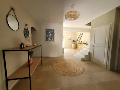 a living room with a hallway with a mirror and stairs at Escapade en Provence, Gîte à Lagnes, Luberon, Vaucluse in Lagnes