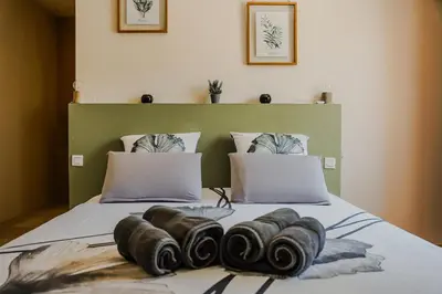 a bed with four pillows on top of it at Escapade en Provence, Gîte à Lagnes, Luberon, Vaucluse in Lagnes