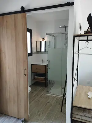 a bathroom with a shower and a glass door at Studio de charme en Provence in Caromb