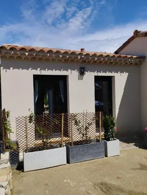 a house with a fence in front of it at Studio de charme en Provence in Caromb
