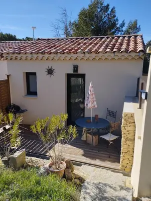 a wooden deck in front of a house at Studio de charme en Provence in Caromb