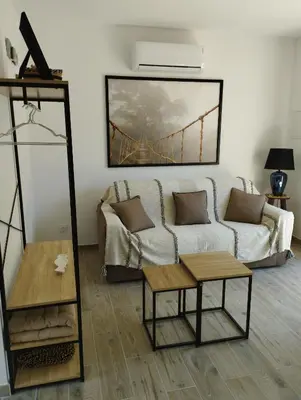 a living room with a couch and a table at Studio de charme en Provence in Caromb