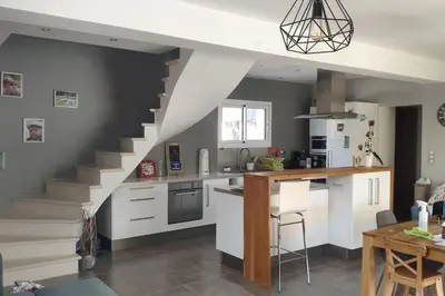 a kitchen with white cabinets and a staircase at Maison avec piscine en Provence in Saint-Cannat