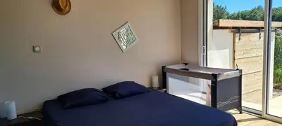 a bedroom with a blue bed and a window at Maison avec piscine en Provence in Saint-Cannat