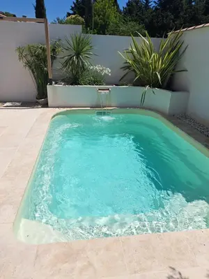 a small swimming pool with blue water in a backyard at Maison avec piscine en Provence in Saint-Cannat