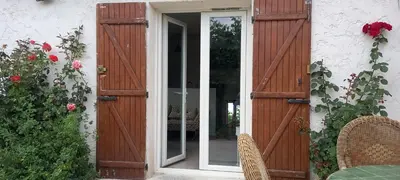 an open door to a house with roses at Campagne Carbonel in Aix-en-Provence