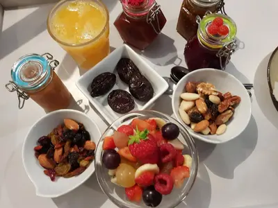 a table with three bowls of fruit and other food at A l'Orée du Pin in Puyricard