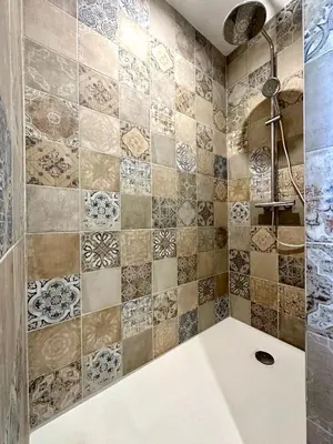 a bathroom with a tub and a tile wall at Villa Saint Jean En Provence in Châteaurenard