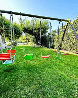 a group of swings in a park at Villa Saint Jean En Provence in Châteaurenard