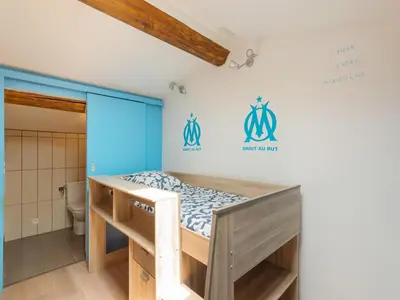 a bunk bed in a room with a bathroom at Holiday Home in Vaucluse near Mont Ventoux in Pernes-les-Fontaines