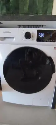 a microwave oven with a cat sitting inside of it at Gîte Aux Bons Voisins in Gordes