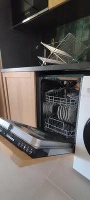 an oven with a rack of dishes in it at Gîte Aux Bons Voisins in Gordes