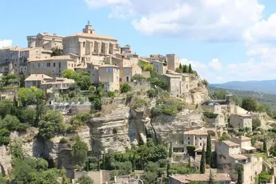 a village on top of a mountain at Gîte Aux Bons Voisins in Gordes