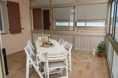 a living room with two couches and a tv at Gîte de campagne Clos Beau Soleil in Caumont-sur-Durance