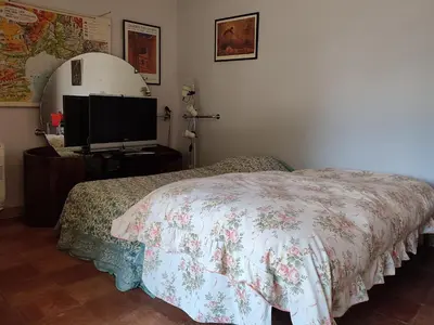 a bedroom with a bed and a flat screen tv at Holiday Home La Tourelle des Ocres by Interhome in Roussillon