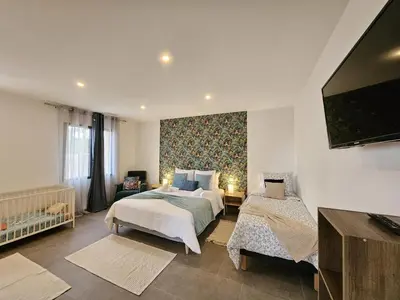a bedroom with two beds and a flat screen tv at Villa lavandin in Apt