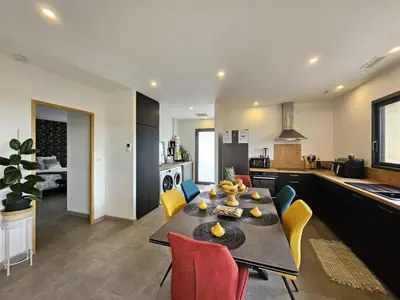 a living room and kitchen with a table and chairs at Villa lavandin in Apt