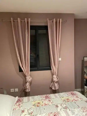 a bedroom with a bed and a window with curtains at VILLA NOUNOU in Le Thor