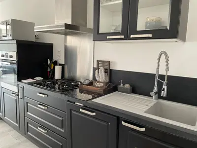 a kitchen with a sink and a stove at VILLA NOUNOU in Le Thor