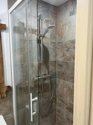 a shower with a glass door in a bathroom at Chambre Mignet in Aix-en-Provence
