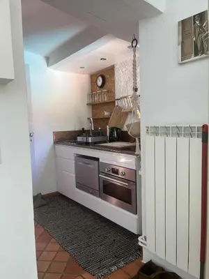 a kitchen with a sink and a stove at Agréable maison de 65 m2 avec grande piscine in Aix-en-Provence