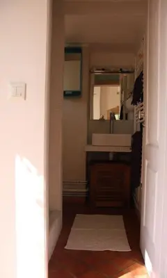 a hallway with a bathroom with a sink and a mirror at Agréable maison de 65 m2 avec grande piscine in Aix-en-Provence
