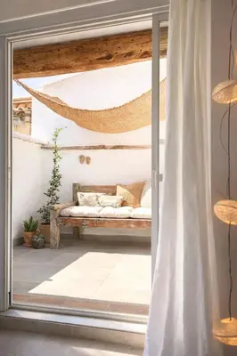 a room with a hammock outside a window at La terrasse du pont jullian charme et calme dans le cœur historique in LʼIsle-sur-la-Sorgue
