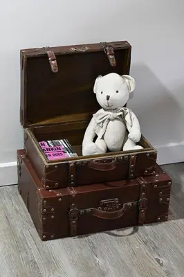 a teddy bear sitting on top of two suitcases at La Villa Moderna in Robion en Luberon