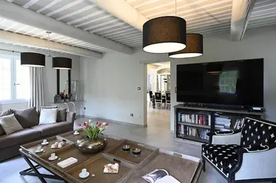 a living room with a couch and a table at La Villa Moderna in Robion en Luberon