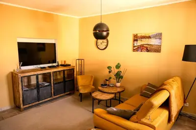 a living room with a couch and a tv at Village house of Jean in Gordes