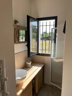 a bathroom with a sink and a glass shower at Contemporary house 5mn away from Aix in the countryside in Aix-en-Provence