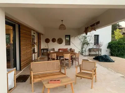 a patio with a table and chairs and a dining room at Contemporary house 5mn away from Aix in the countryside in Aix-en-Provence