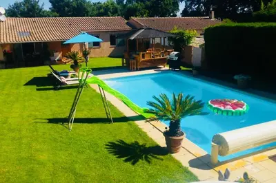 a living room with a table and chairs and a couch at Charming Villa with pool, close to city center in Aix-en-Provence
