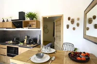 a kitchen with a table with a bowl of fruit on it at Les Agapanthes de Gordes in Gordes