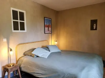 a bedroom with a large bed with two pillows at Magnifique Mas Provençal in Lauris