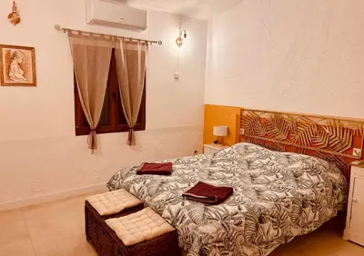 a bedroom with a bed and a window at Maison à Gordes dans le Lubéron in Gordes