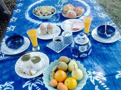 a blue table topped with plates and bowls of food at L'Islo Bamboo in Saumane-de-Vaucluse